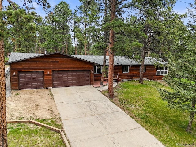 26499 W St, Conifer, CO 80433 - chalet / cabin with driveway, an attached garage, and a front yard