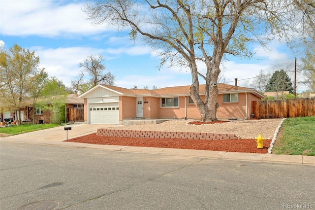 single story home with fence, an attached garage, and concrete driveway