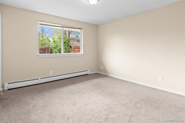 empty room featuring baseboard heating, carpet flooring, and baseboards