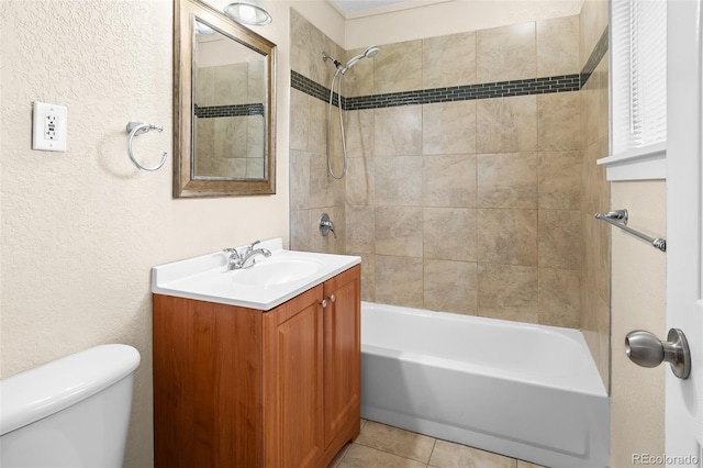 bathroom with shower / bath combination, vanity, toilet, tile patterned floors, and a textured wall