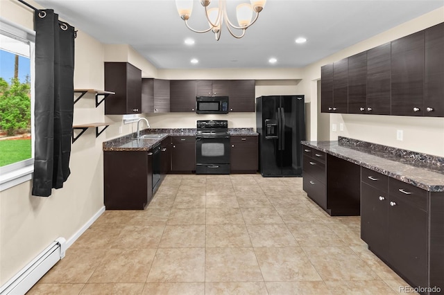 kitchen featuring black appliances, a baseboard radiator, a sink, a chandelier, and dark stone counters