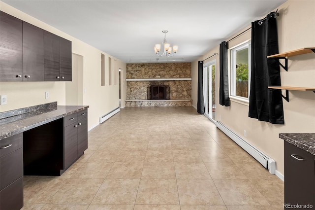 kitchen with a baseboard radiator, a baseboard heating unit, a chandelier, open floor plan, and a fireplace