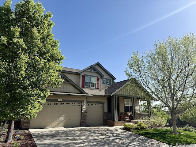 10565 Kicking Horse Dr, Littleton, CO 80125 - craftsman-style house with a porch, board and batten siding, driveway, and stone siding