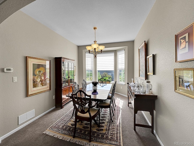 10565 Kicking Horse Dr, Littleton, CO 80125 - dining area featuring a chandelier, carpet, a textured wall, and baseboards