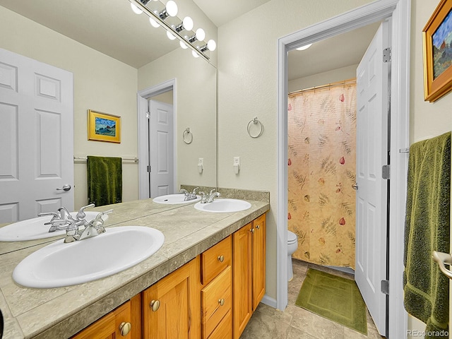 10565 Kicking Horse Dr, Littleton, CO 80125 - bathroom featuring toilet and double vanity