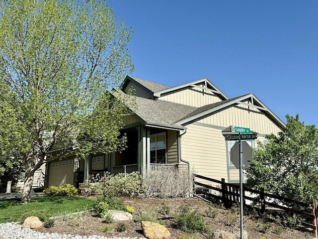 10565 Kicking Horse Dr, Littleton, CO 80125 - view of home's exterior with roof with shingles and covered porch