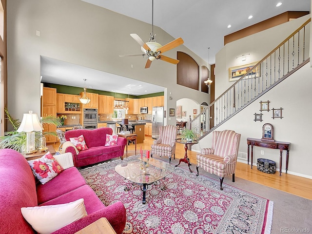 10565 Kicking Horse Dr, Littleton, CO 80125 - living area with recessed lighting, a high ceiling, a ceiling fan, stairway, and arched walkways
