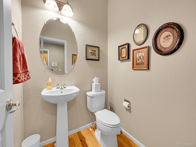 10565 Kicking Horse Dr, Littleton, CO 80125 - half bathroom with wood finished floors and toilet