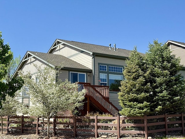 10565 Kicking Horse Dr, Littleton, CO 80125 - view of front of home featuring board and batten siding, a shingled roof, and stairs