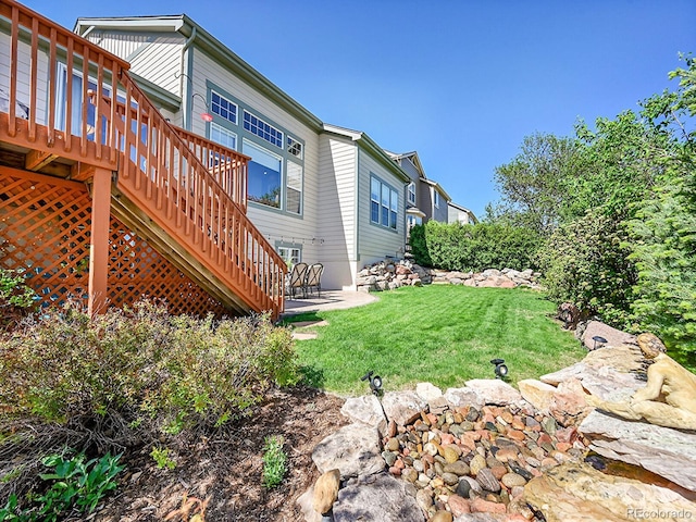10565 Kicking Horse Dr, Littleton, CO 80125 - view of green lawn with a deck