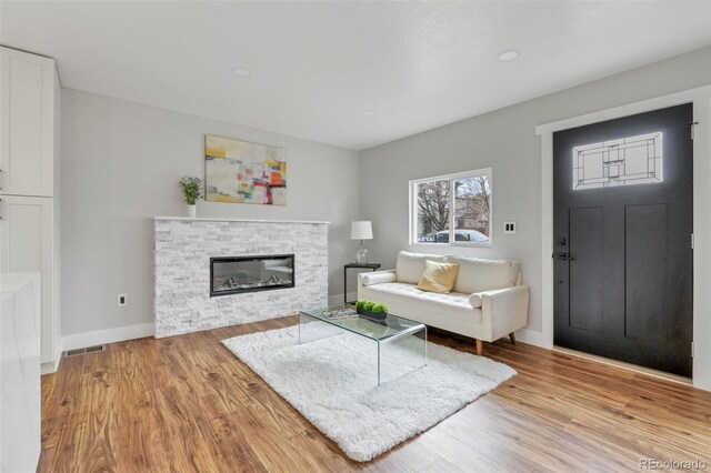 living room with a fireplace and light hardwood / wood-style floors