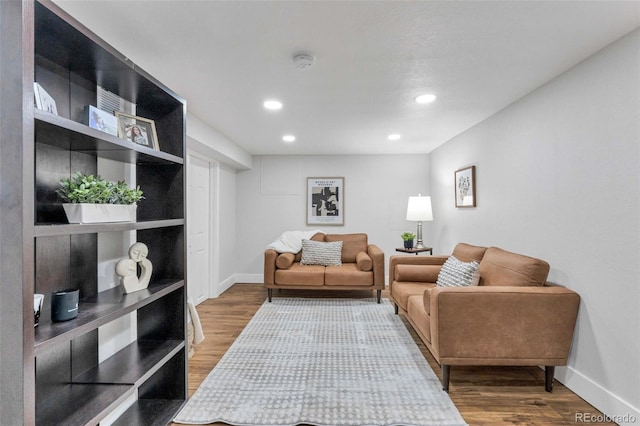 living room featuring recessed lighting, baseboards, and wood finished floors