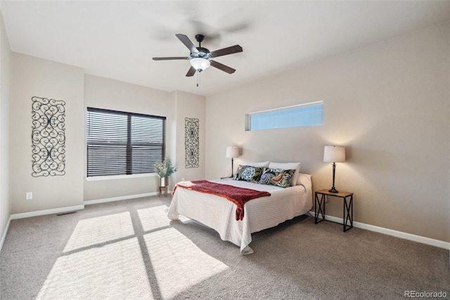 carpeted bedroom featuring ceiling fan and multiple windows