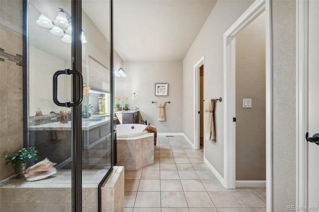 bathroom with tile patterned flooring, vanity, and separate shower and tub