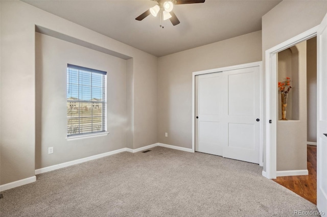 unfurnished bedroom featuring carpet flooring, ceiling fan, and a closet