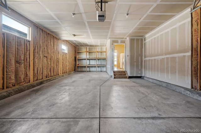 garage with a garage door opener and wooden walls