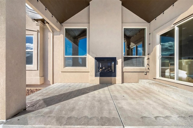 view of patio featuring a multi sided fireplace