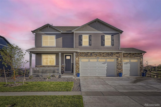 7702 E 159th Ave, Thornton, CO 80602 - view of front facade with covered porch, concrete driveway, stone siding, roof with shingles, and an attached garage