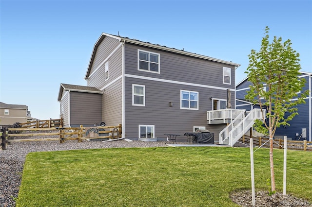 7702 E 159th Ave, Thornton, CO 80602 - back of property featuring a wooden deck, stairs, and a patio area