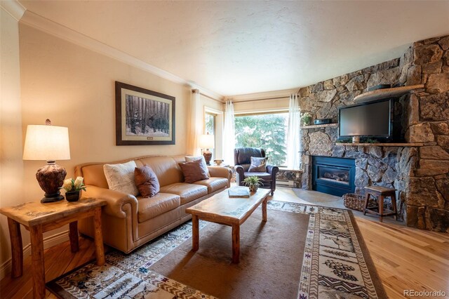 765 Columbine St Unit C203, Breckenridge, CO 80424 - living area featuring wood finished floors, a stone fireplace, and crown molding
