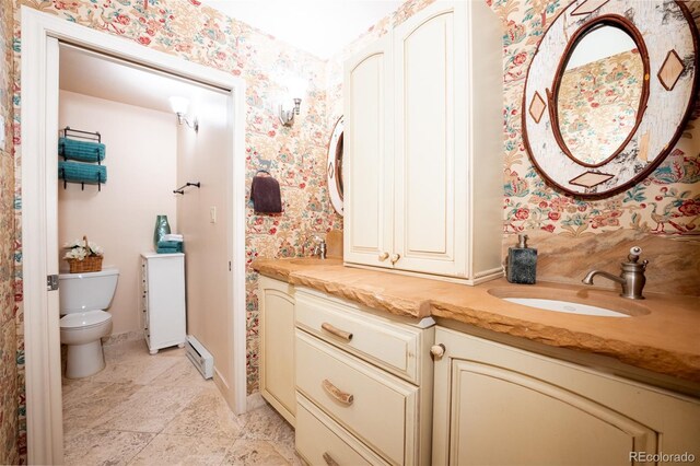 765 Columbine St Unit C203, Breckenridge, CO 80424 - bathroom with wallpapered walls, vanity, toilet, a baseboard radiator, and stone finish flooring