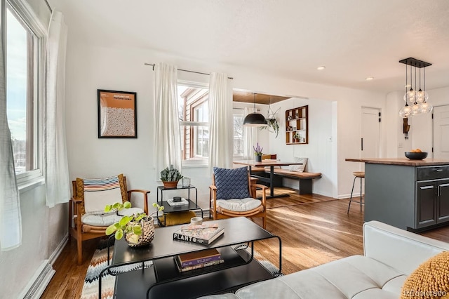 living area featuring dark wood-style floors, baseboards, baseboard heating, and recessed lighting