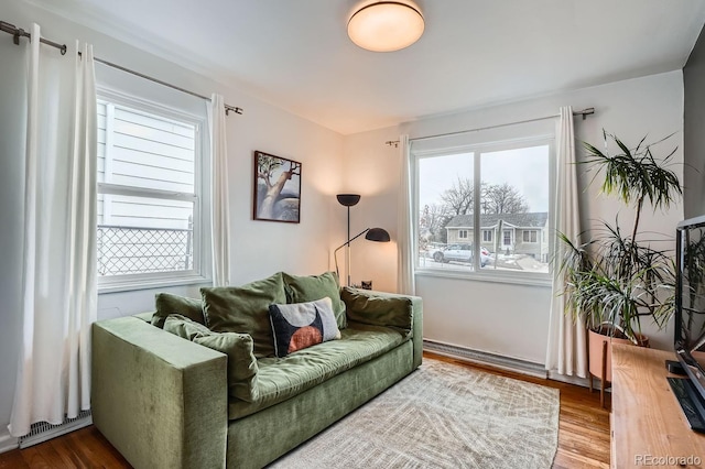 living area with visible vents and wood finished floors