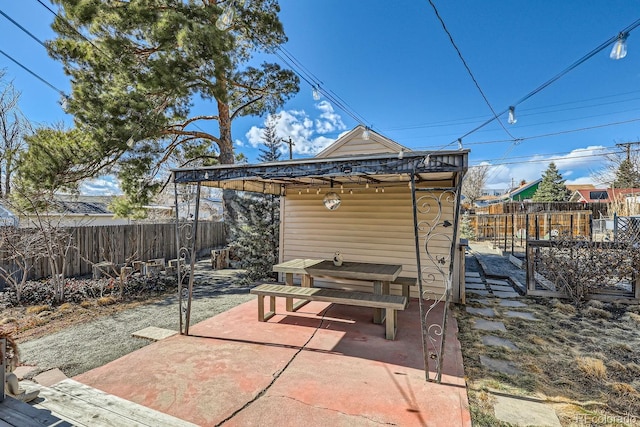 view of patio / terrace with a fenced backyard and an outbuilding