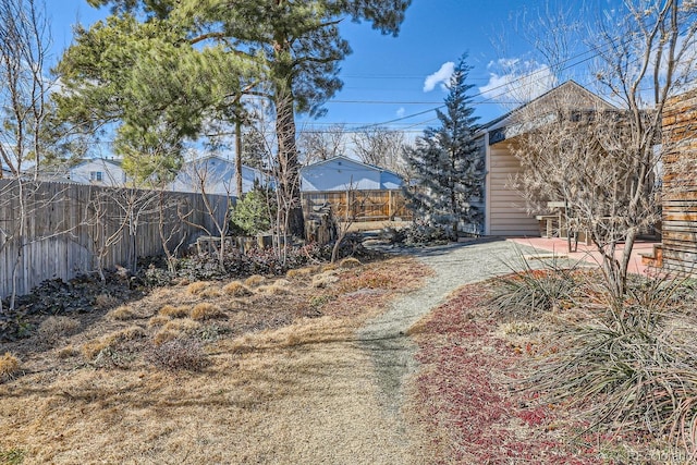 view of yard featuring fence and a patio