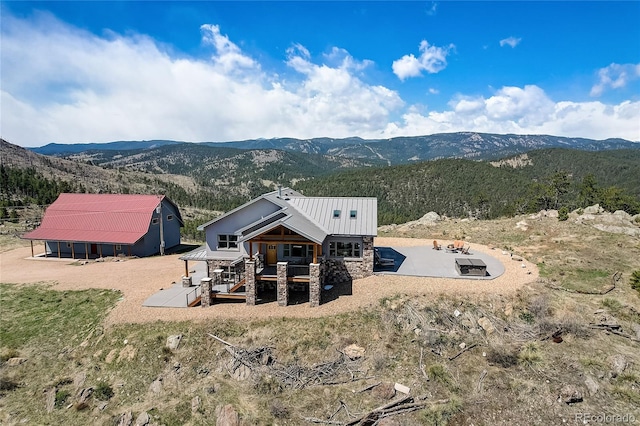 back of property with a mountain view