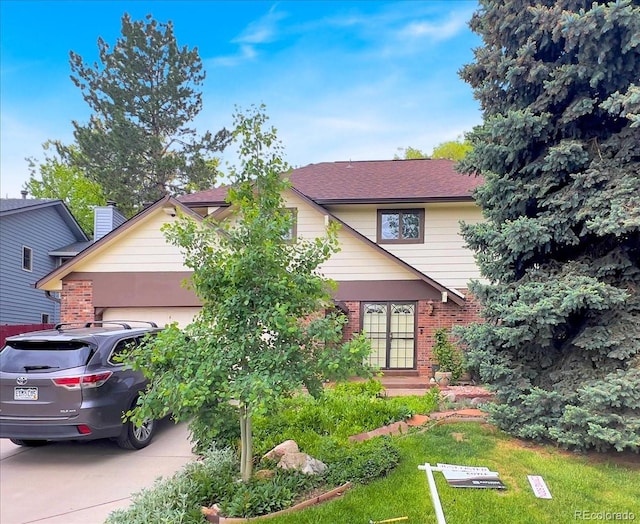 7217 S Zephyr Way, Littleton, CO 80128 - view of front of house with a garage, brick siding, and concrete driveway