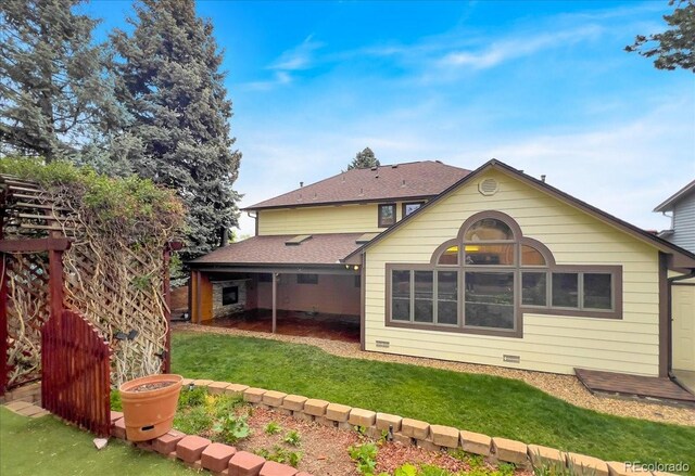 7217 S Zephyr Way, Littleton, CO 80128 - back of house with a yard and roof with shingles