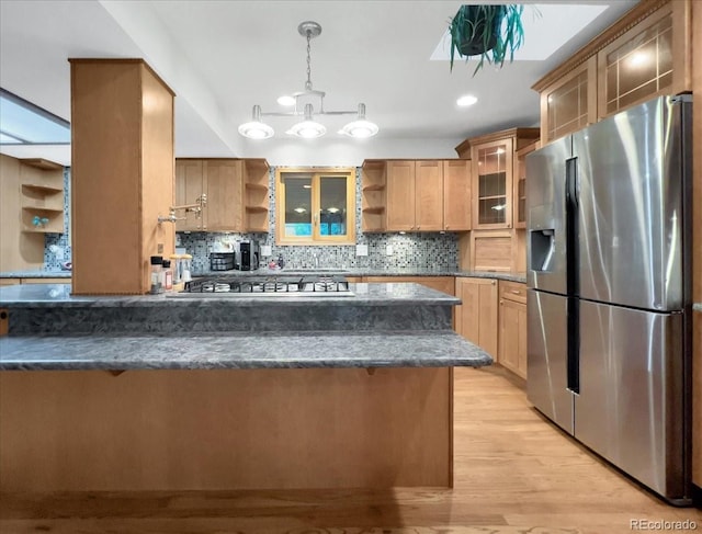 7217 S Zephyr Way, Littleton, CO 80128 - kitchen with stainless steel appliances, open shelves, light wood-style flooring, and decorative backsplash