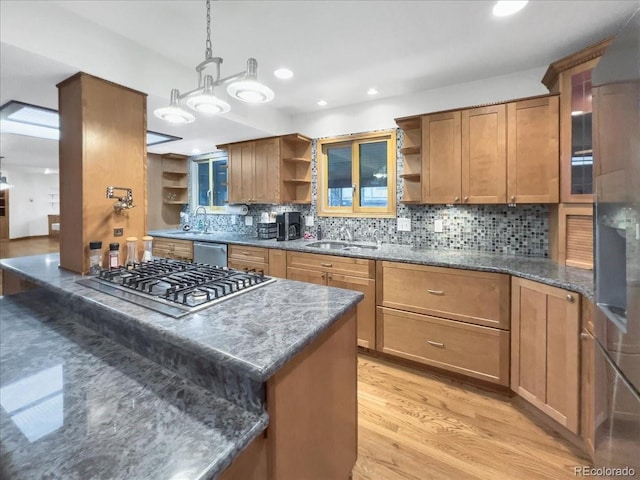 7217 S Zephyr Way, Littleton, CO 80128 - kitchen with open shelves, stainless steel gas cooktop, a sink, brown cabinets, and tasteful backsplash