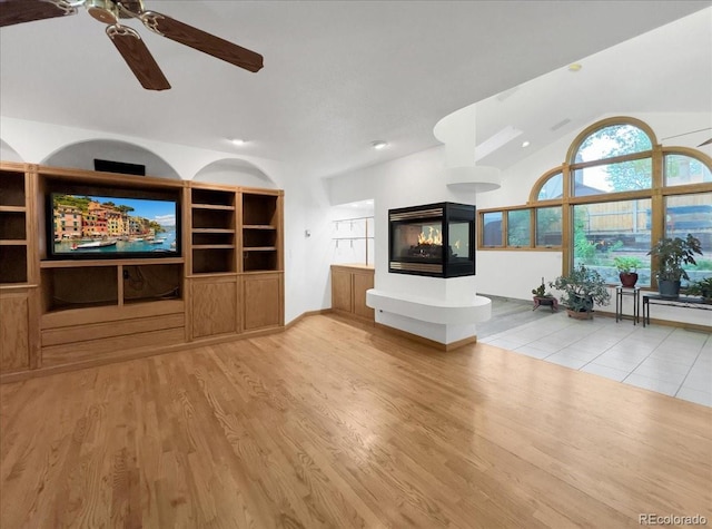 7217 S Zephyr Way, Littleton, CO 80128 - unfurnished living room with ceiling fan, vaulted ceiling, wood finished floors, and recessed lighting