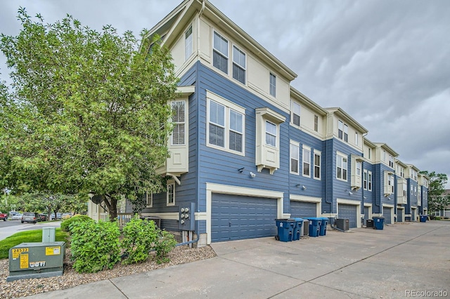 exterior space with cooling unit and a garage