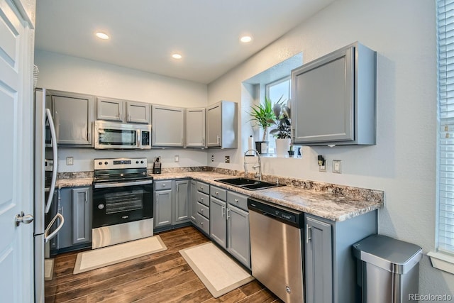 kitchen featuring gray cabinets, sink, stainless steel appliances, and dark hardwood / wood-style floors