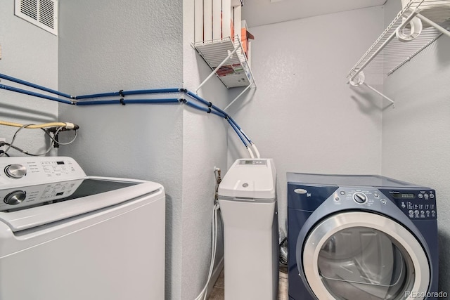 laundry area with washing machine and clothes dryer