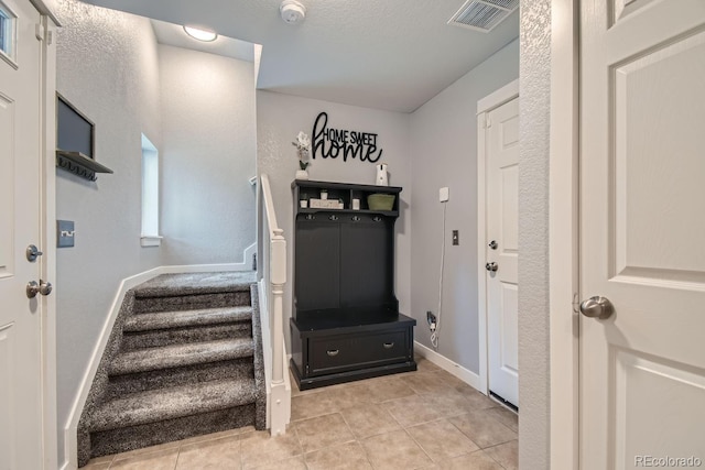 mudroom with light tile patterned floors