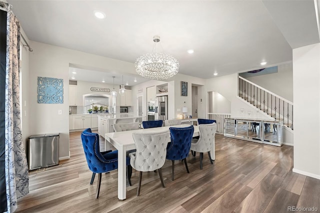 dining space featuring a notable chandelier and wood-type flooring