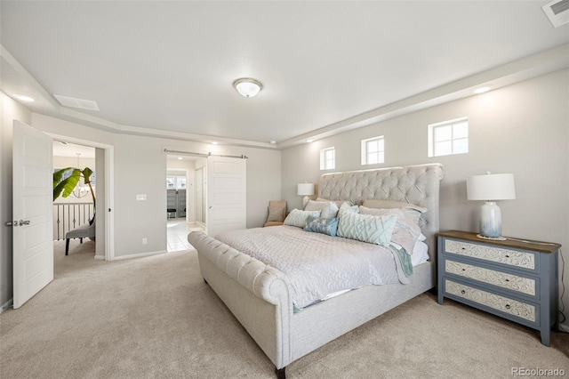 carpeted bedroom with a barn door