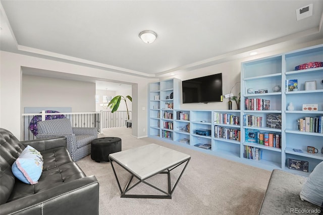 carpeted living room with built in shelves