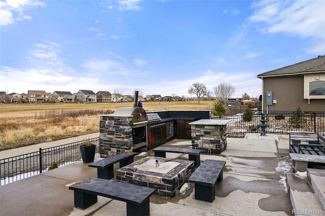 view of patio / terrace featuring a fireplace and an outdoor kitchen