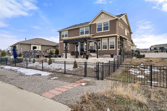 view of front of house featuring a pergola and a patio