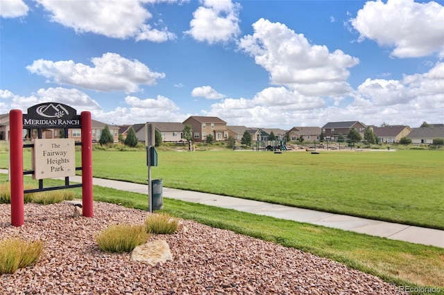 view of property's community with a lawn