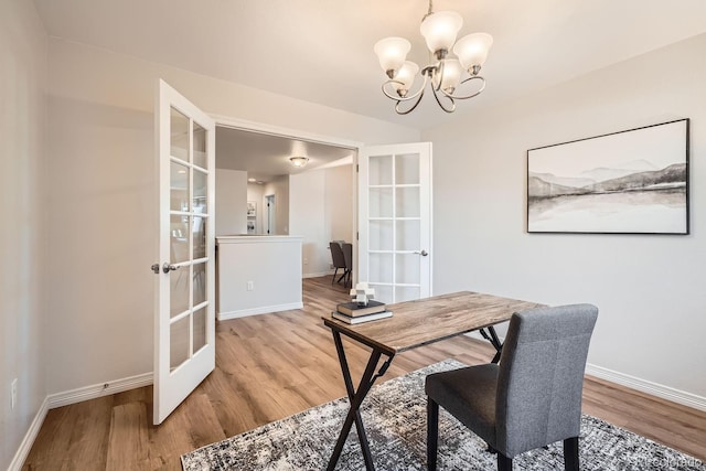 office with hardwood / wood-style floors, a chandelier, and french doors