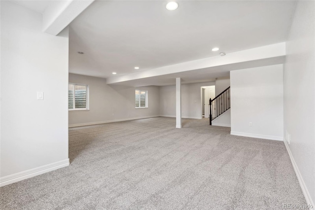 basement featuring light carpet