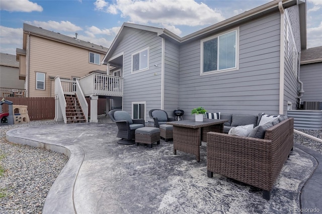 back of property with a wooden deck, central AC, outdoor lounge area, and a patio area