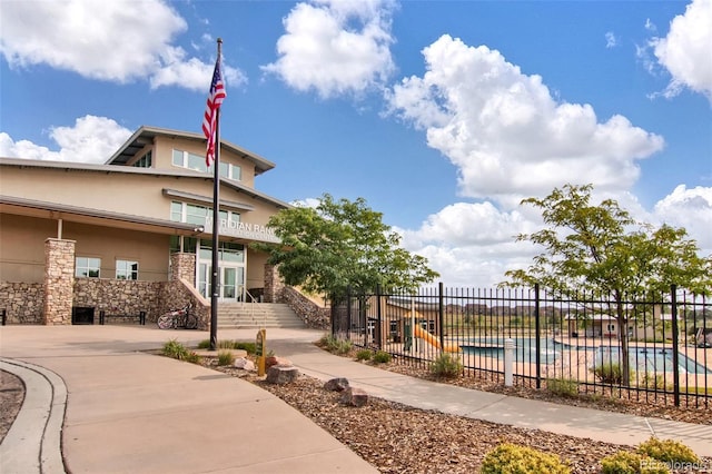 exterior space with a fenced in pool