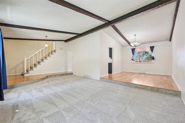 unfurnished living room featuring wood-type flooring, a chandelier, lofted ceiling with beams, and a textured ceiling